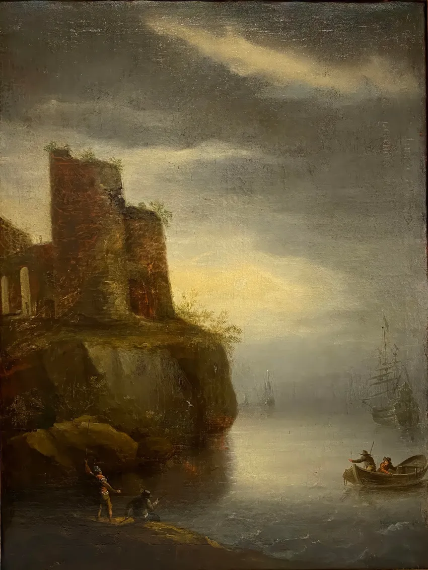 Boats near rocky shore at sunset