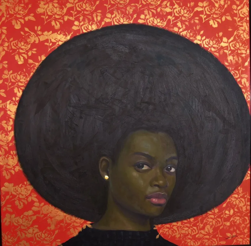 Woman with afro, red patterned backdrop