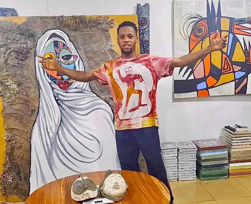 Artist posing with colorful abstract paintings