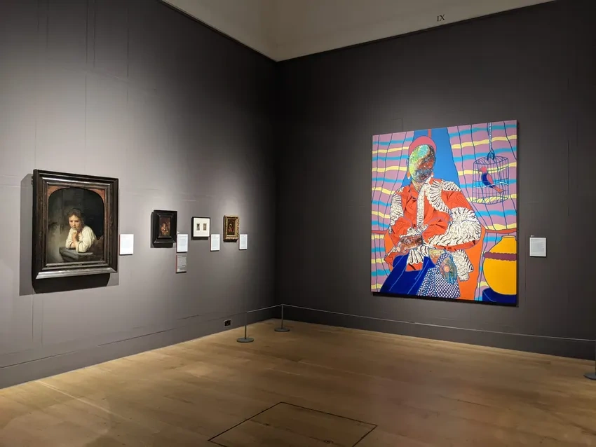 Art gallery with diverse paintings displayed.