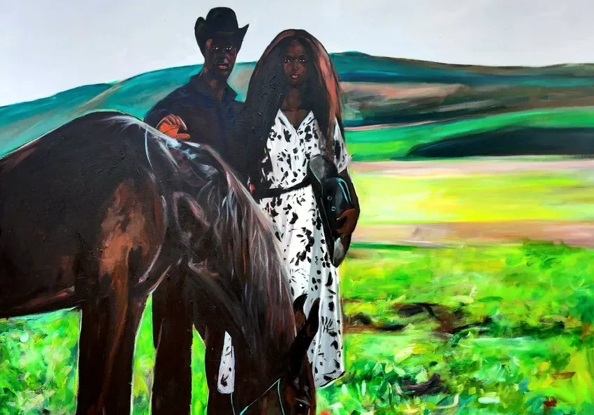 Cowboy and woman with horse in field