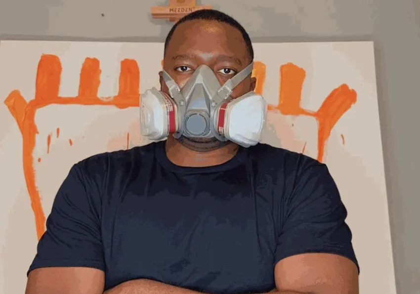 Painter with crossed arms and respirator