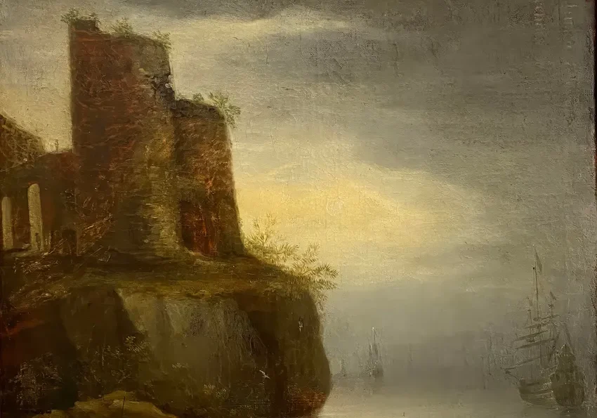 Boats near rocky shore at sunset