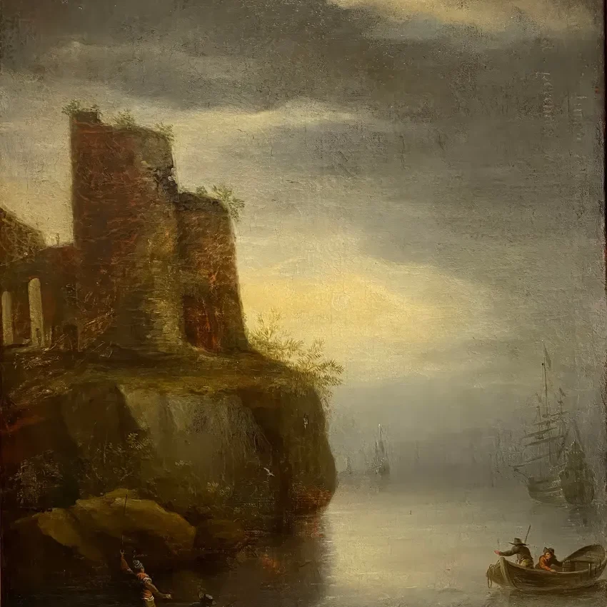 Boats near rocky shore at sunset