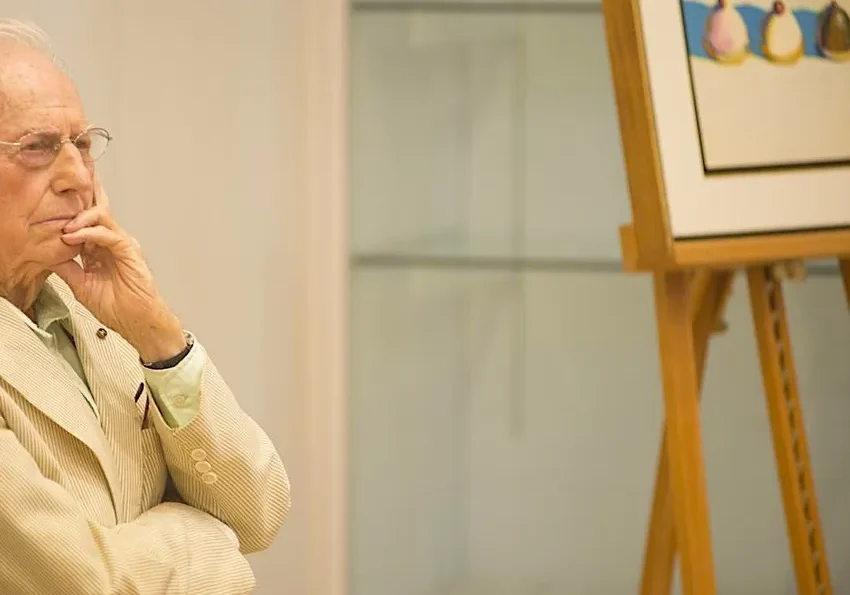 Thoughtful man beside framed artwork